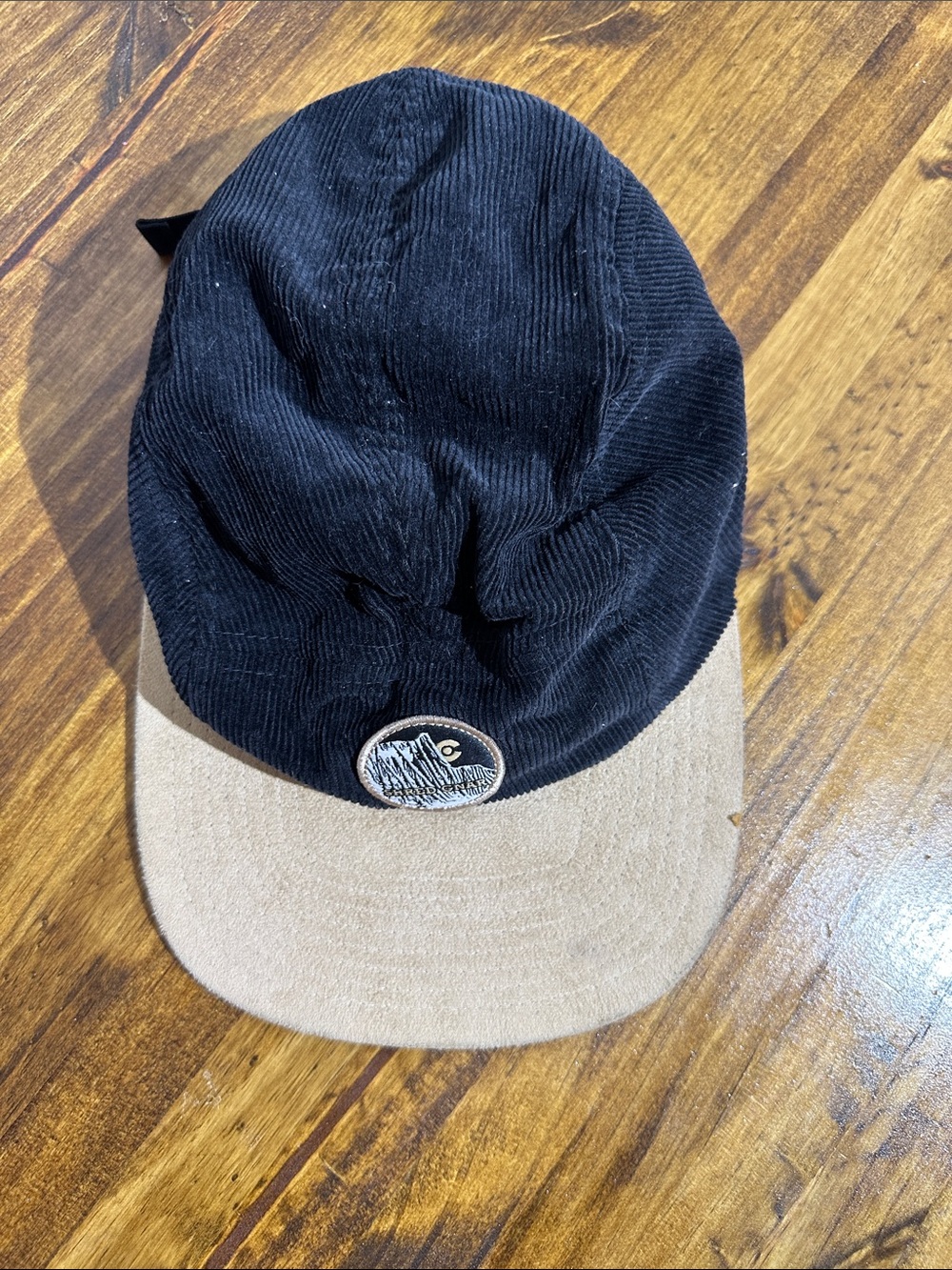 Men's Two-Tone Corduroy Cap in Black and Tan with Mountain Patch - Unbranded